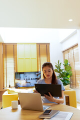 Woman enjoys book and music in modern abode.