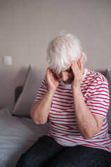 Worried senior woman at home felling very bad