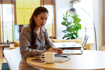 Woman enjoys book and music in modern abode.