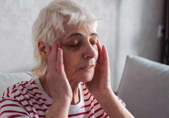 Old Age, Health Problem, Vision and People Concept - Close Up of Senior Woman Sitting on Sofa and...