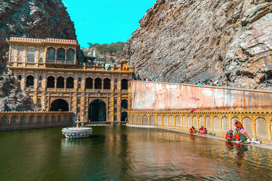 GaltaJi, the Ancient Monkey Temple near Jaipur, Rajasthan &ndash; Local Women Washing Clothes at the Sacred Water Pools Amidst Monkeys and Historic Architecture