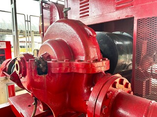 old industrial machine. Bright red industrial fire pump system, used in emergency response within large-scale manufacturing facilities or warehouses.