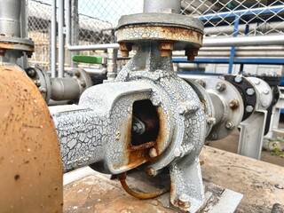 old industrial machine, Close-up of an old industrial pump with cracked paint and visible rust,...