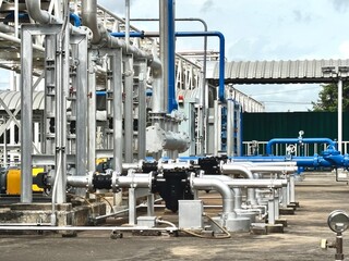industrial power plant.Industrial electric motor pumps installed outdoors with connected pipelines...