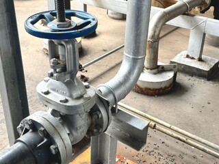 pipes and valves , Close-up of industrial pipeline system with handled valve and pressure gauge. Used in HVAC, water distribution, and process control systems.