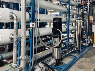  Industrial reverse osmosis filtration system with stainless steel piping and control valves, used for water treatment in manufacturing.