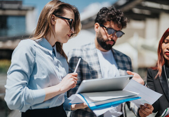 A group of people engaging in a collaborative session, working on documents and utilizing modern...
