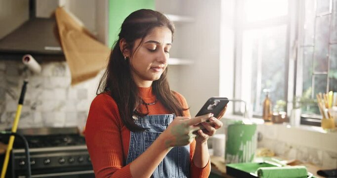 Phone, smile and remodeling with woman in kitchen for subcontractor research, project and paint idea. Home improvement, renovation and diy supplier contact with person in house for communication