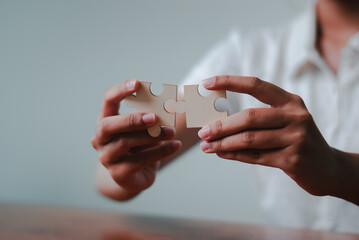 Collaborative business strategy planning hands joining puzzle pieces a professional office...