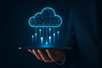 Businessman holding tablet with glowing cloud upload icon and digital arrows showing cloud data transfer and technology concept in dark background