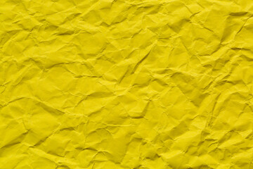 Close-up macro of yellow crumpled paper,Crumpled yellow paper background. Real macro battered...