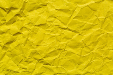 Close-up macro of yellow crumpled paper,Crumpled yellow paper background. Real macro battered texture. Close up photo.