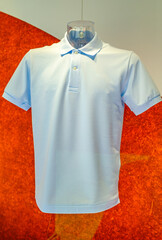 Light blue polo shirt displayed in a retail setting with a vibrant background highlighting casual...