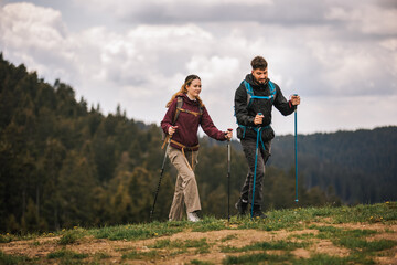 Young Couple Hiking in the Mountains Admiring Nature with Full Gear