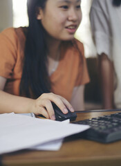 Asian children using digital tablet with stylus pen write and do homework at home. Stress Thai Student working online to study for the exam. Education and E-learning concept-vertical image.
