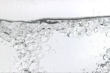 Crystal-clear liquid with rising bubbles, symbolizing purity, hydration, and freshness. Perfect for...