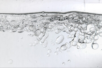 Crystal-clear liquid with rising bubbles, symbolizing purity, hydration, and freshness. Perfect for...