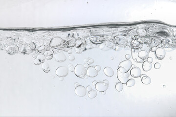 Crystal-clear liquid with rising bubbles, symbolizing purity, hydration, and freshness. Perfect for...