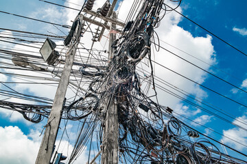 lots of coiled electrical wires wires on poles