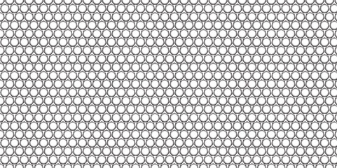 Abstract dark metallic carbon fiber texture with a seamless grid pattern and perforated steel surface design