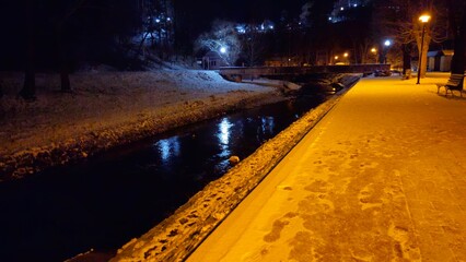 winter in the city park next to the river