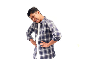 Young Asian man in plaid shirt experiencing intense abdominal pain on white background