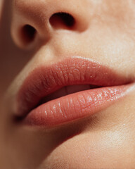 Fototapeta premium Gentle close up of lips showcasing natural shade, highlighting smooth texture and subtle shine, evoking sense of beauty and elegance