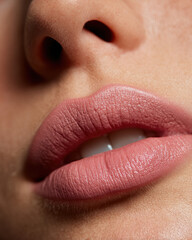 Soft rosy beige tone matte lips create stunning close up, showcasing smooth texture and natural beauty. subtle shine enhances overall look, evoking sense of elegance and allure