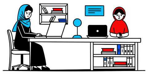Two Women in Hijabs Working Together at a Desk in an Office