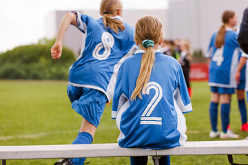 Youth Girls’ Soccer Match. Team Players in Blue Jerseys on Sidelines and Entering the Field. European Football Tournament For Female Teams