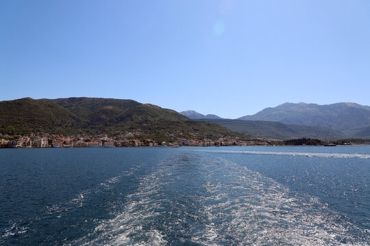 Panorama of the city of Tivat, Montenegro. Vertical photo, view from the water, from the departing ferry. Sea, city, boats