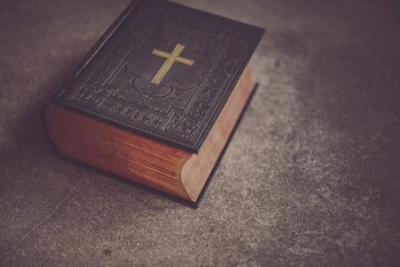A classic leather-bound Holy Bible with a cross symbol on the cover.