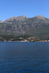 View of the mountains and the city of the Bay of Kotor in Montenegro. Mountains from the rocks. Blue sea, View from the boat