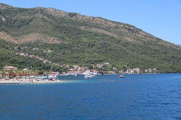 City with a pier for boats and motorboats with beaches in the Bay of Kotor Montenegro. Horizontal photo