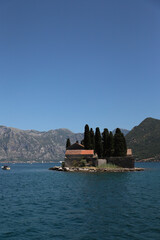 Saint George island against the backdrop of mountains, sea and sky, Montenegro. View of the entire island
