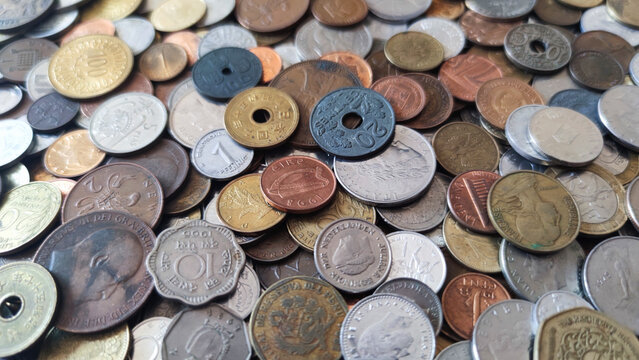 Coins from around the world. Numismatics. Coins background. Heap of various coins. Coins collection.