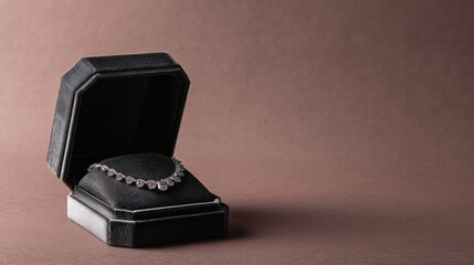 A diamond necklace in a black jewelry box against a brown background