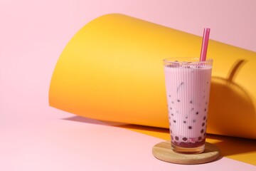 Tasty milk bubble tea in glass on color background, space for text