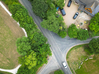 Aerial top down view of a single vehicle passing an accident prone crossing blackspot in the UK....