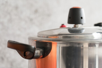 Close-up of pressure cooker with neutral gray background and copy space