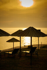 Porec beach on the Croatian Adriatic coast with parasols and sun loungers in the evening before sunset
