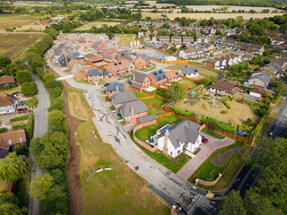 Drone view of a partially completed, exclusive housing development seen in rural Essex. The large White House at the beginning of the estate is the largest here.