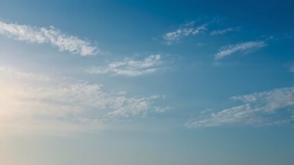 Obraz premium Beautiful blue sky with wispy clouds showing a natural and peaceful atmosphere