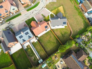 Drone top down view of newly completed private houses and bungalows seen on the edge of a new housing development in Britain. Within a few weeks, new home owners would have moved in.