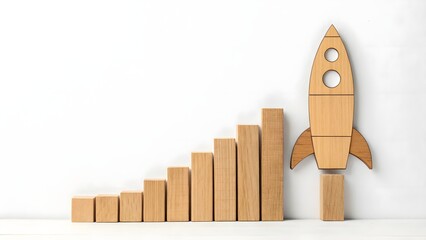 Wooden Blocks Forming Rocket Next to Growing Bar Graph on White