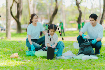 Asian family on summer vacation, parents teaching children to pick up plastic bottles and trash in...