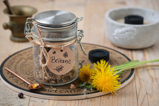 Beltane incense blend with frankincense, resins and herbs on wooden table