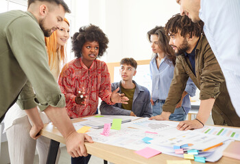 Team of colleagues collaborates on creating a business plan and management tasks and engaged in a...