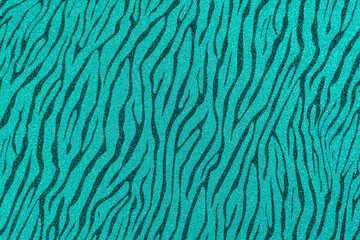 Texture of colored paper. Decorative sheet of cardboard with a zebra pattern. Turquoise glitter background