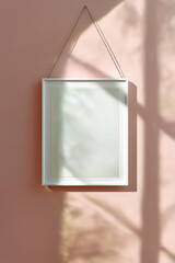 Empty white picture frame hanging on pastel pink wall with shadowed window reflections, minimalist decor, modern gallery, empty space, interior design, art display, wall art, frame, shadow